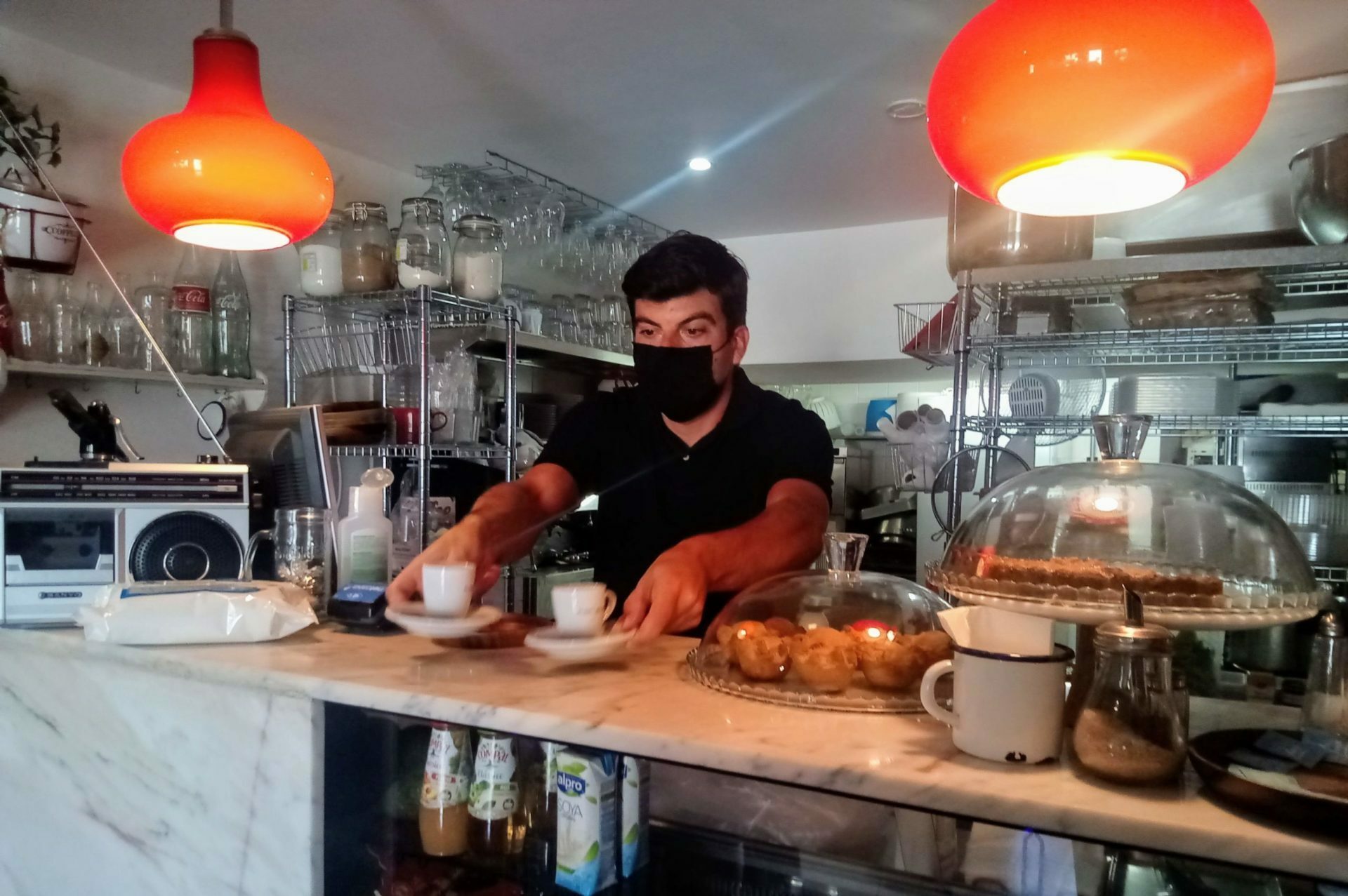 Miguel Barros serves coffee in his bar.