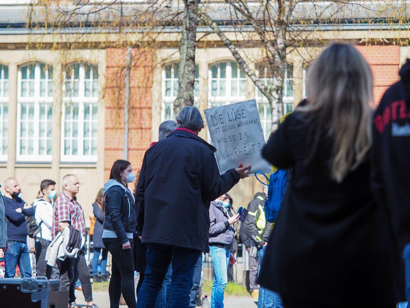 A participant of the demonstration holds a poster that reads: 